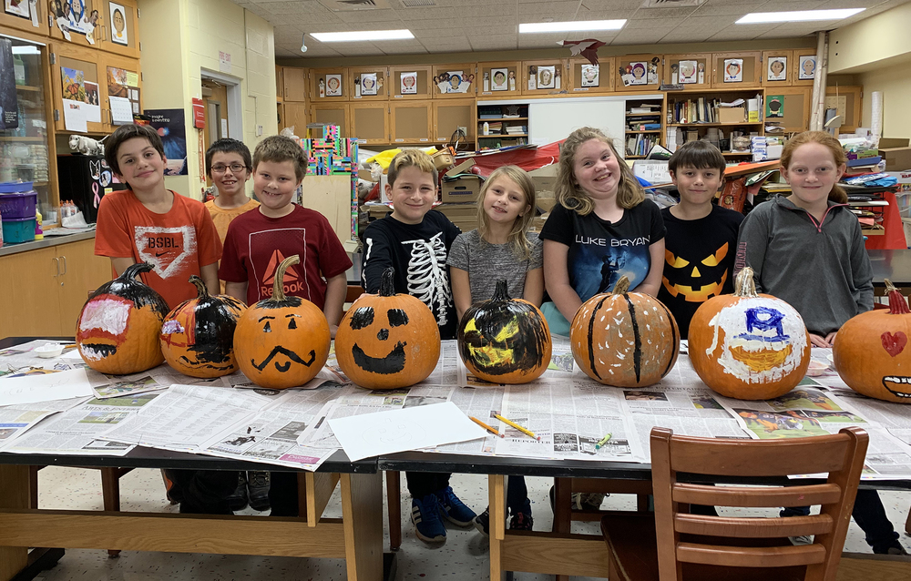 students with decorated pumpkins