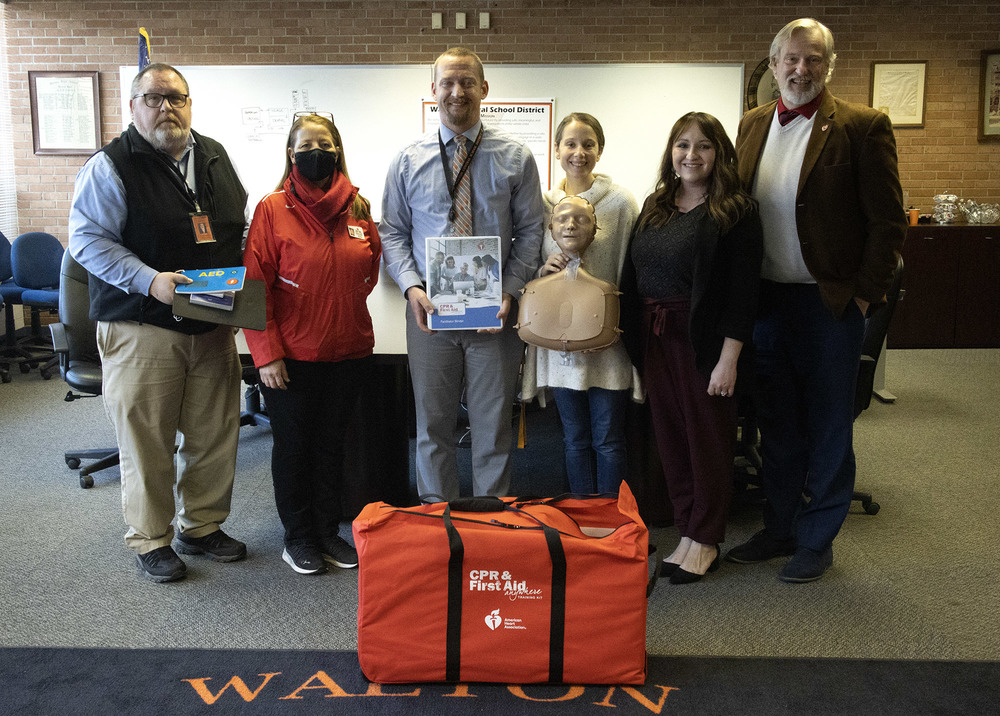 Members of the AHA donate the CPR units to Walton CSD