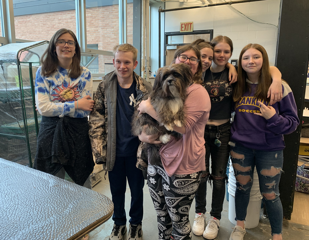 Students with dog after grooming lesson