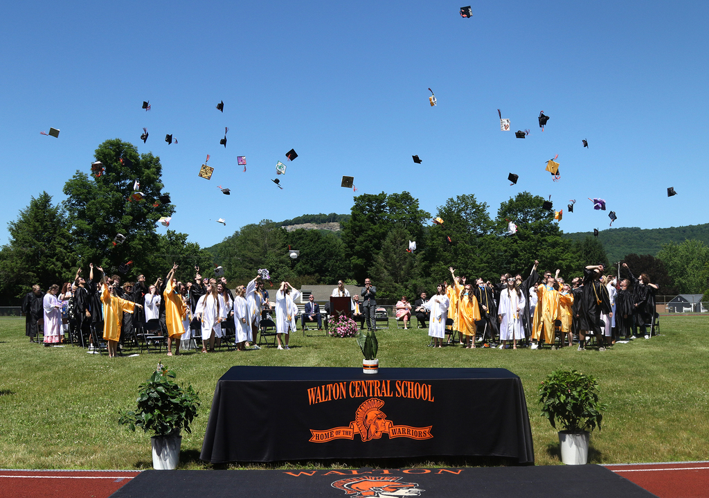 The class of 2022 throws their caps into the air. 