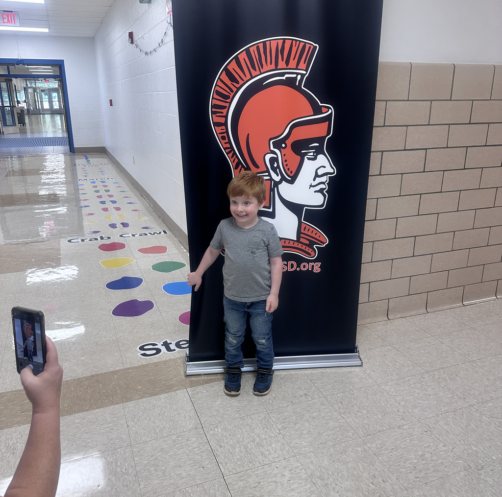 Student in front of Walton backdrop